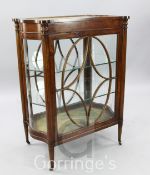 An Edwardian inlaid mahogany free-standing bijouterie cabinet, with all-round glazing, serpentine