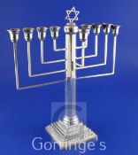 A 1940's silver Hanukkah Menorah, with tapering octagonal stem, on stepped square base, maker, R.