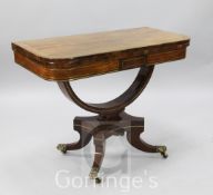 A Regency brass strung rosewood card table, with folding D shaped top and U shaped stem, on