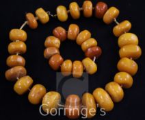 A single strand disc shaped amber bead necklace and matching bracelet, gross weight 187 grams,