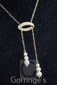 An Edwardian 15ct gold, simulated pearl and seed pearl drop pendant necklace, the fine link chain