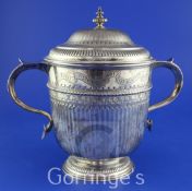 A George V demi-fluted silver two handled presentation cup and cover with inscription relating to
