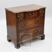 A mid 18th century mahogany chest, with unusual serpentine top over three short and two long