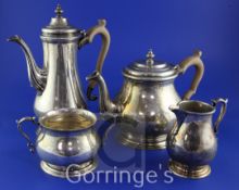 A 1960's/1970's four piece silver tea and coffee service, of baluster form, with wooden handles