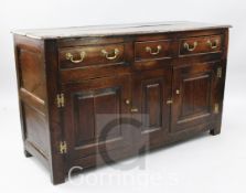 A mid 18th century oak dresser base, with three drawers over two panelled doors, on stile feet, W.