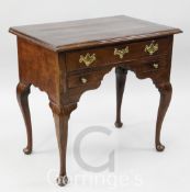 A George II mahogany lowboy, with crossbanded top and three drawers, on cabriole legs, W.2ft 6in. D.