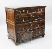 A 17th century oak chest, of two short and three long drawers, with geometric moulding and