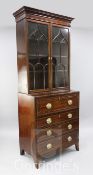 A George III mahogany secretaire bookcase, of narrow proportions, the inlaid cornice above arched