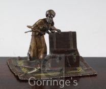 An Austrian cold painted bronze group of an Arab weapons seller, standing upon a carpet, 4.75in.