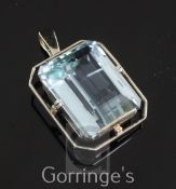 A white gold and aquamarine drop pendant, the emerald cut stone weighing approximately in excess