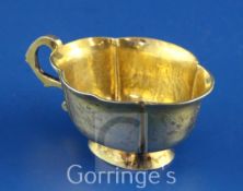 A late 18th century Russian silver gilt vodka cup, of cusped oval form with engraved foliate