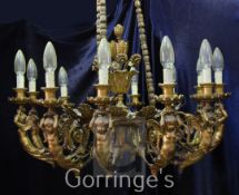 A large 20th century gilt metal and wood twelve light electrolier, of ornate scrolling foliate