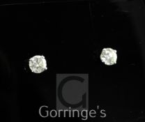 A pair of 18ct white gold and solitaire diamond ear studs, each round brilliant cut diamond weighing