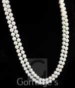 A double strand cultured pearl necklace with stylish 14ct gold, ruby, sapphire and diamond set