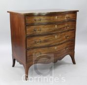 A late Georgian mahogany serpentine chest, of four graduated long drawers, with ivory inset urn