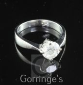 An 18ct white gold and solitaire diamond ring, the round cut stone weighing approximately 1.10ct,