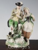 A Ralph Wood (the younger) lead-glazed group of a shepherd and shepherdess, c.1780-1800, both seated