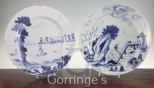 Two English delft ware chargers, the first painted with a European scene of figures on a lake, the