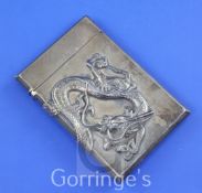 A Japanese silver card case cast with a sinuous dragon, of rectangular form, character marks en