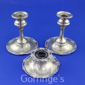 A pair of George V silver desk dwarf candlesticks and a matching silver inkwell with tortoiseshell