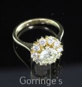 An Italian 18ct gold and diamond cluster ring, with central round brilliant cut diamond weighing