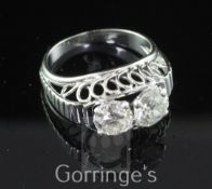 A mid 20th century French 18ct gold, platinum and two stone diamond ring, with raised pierced loop