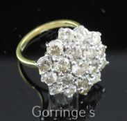 A late 1970's 18ct gold and diamond cluster ring, of flower head design, size O.