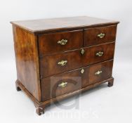 A George I crossbanded walnut chest, of two short and two long drawers, the upper drawers with