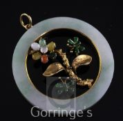 A 14ct gold, jade and cabochon gem set open disc pendant, with central foliate motif, 2.25in.