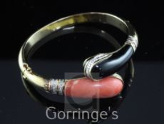 A 14ct gold, coral, black onyx and diamond hinged bangle, the serpent head shaped terminals set with