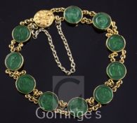 A Chinese high carat double chain link gold and jadeite bracelet, set with ten circular discs carved