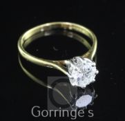 An 18ct gold and solitaire diamond ring, the round brilliant cut stone weighing approximately 0.70-