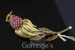 An 18ct gold and ruby trembleuse brooch modelled as an exotic fruit, set with cabochon and round cut