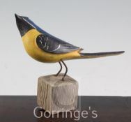 § Guy Taplin (1939-)painted wood,Yellow Wagtail perched on a stump,signed and dated 2000,height