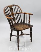 An early 19th century yew, elm and ash Windsor chair, with roundel carved splat, H.2ft 10in.