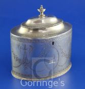 A George III bright cut engraved silver oval tea caddy by Hester Bateman, with engraved armorial and