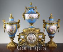 A 19th century French ormolu and jewelled Sevres style porcelain clock garniture, the mantel clock