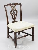 A Chippendale period mahogany dining chair, with owl's eye pierced splat and padded seat, on blind