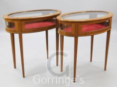 A pair of Edwardian style satinwood display tables, with oval tops and square tapered legs, signed
