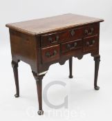 A mid 18th century mahogany lowboy, with rounded rectangular top and frieze drawer over three