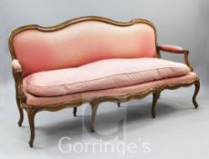 A Louis XVI carved beech canape corbeille, with faded pink upholstery, on cabriole legs, W.6ft