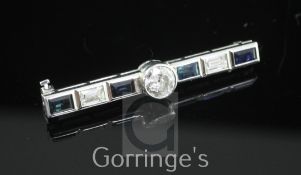 A white gold, sapphire and diamond bar brooch, set with baguette cut sapphires and diamonds and