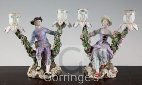 A pair of Meissen figural candelabra, later 19th century, modelled as a lady and a gentleman in 18th