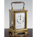 A late 19th century French gilt brass hour repeating carriage clock, the enamelled dial signed