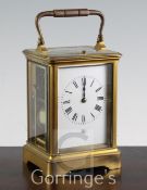 A late 19th century French gilt brass hour repeating carriage clock, the enamelled dial signed