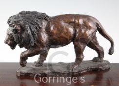 A 20th century bronze model of a lion, with Morris Singer Foundry stamp, length 14.5in.