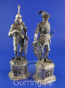 A pair of early 20th century German? parcel gilt silver and carved ivory figures, modelled as