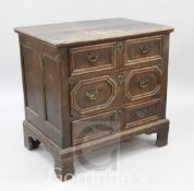 A William III oak chest, c.1700, of small proportions, with planked top, panelled sides and three