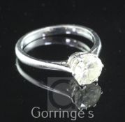 An 18ct white gold and solitaire diamond ring, the round brilliant cut stone weighing