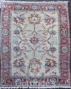 A Persian carpet, with geometric foliate field on an ivory ground, with three row border, 10ft 7in